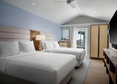 a hotel room with two beds and a television at Shore House at The Del, LXR Hotels & Resorts in San Diego