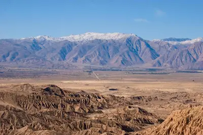 an aerial view of the desert with mountains in the background at Palm Canyon Hotel and RV Resort in Borrego Springs