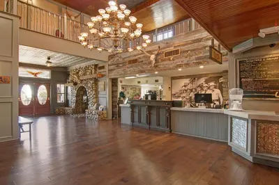 a large room with a bar and a restaurant at Palm Canyon Hotel and RV Resort in Borrego Springs