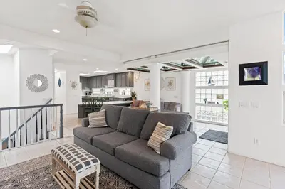 a living room with a couch and a kitchen at The Strand Oasis in Oceanside