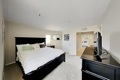 a bedroom with a large bed and a television at Imperial Beach Club in Imperial Beach