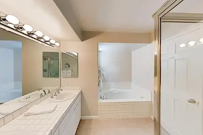 a bathroom with two sinks and a tub at Imperial Beach Club in Imperial Beach