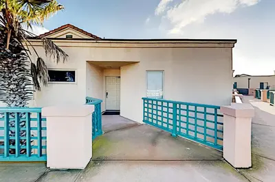a house with a blue and white fence at Imperial Beach Club in Imperial Beach