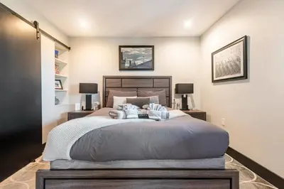 a bedroom with a large bed and two lamps at Contemporary Ocean Sunset Views with Firepit Pt Loma close to PLNU in San Diego