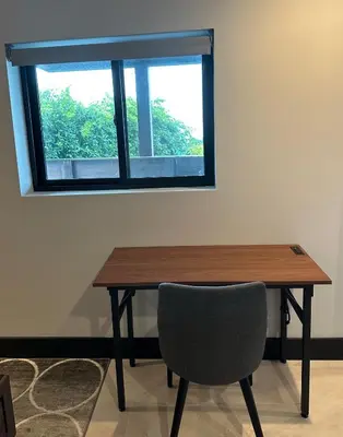 a wooden table with a chair and a window at Contemporary Ocean Sunset Views with Firepit Pt Loma close to PLNU in San Diego