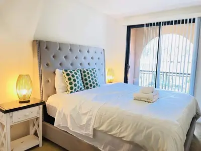 a bedroom with a large bed with a large window at Luxury Irvine 2Bedrooms 2Bathrooms kitchen Pool apartment in Irvine