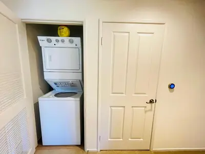 a kitchen with a washer and dryer next to a door at Luxury Irvine 2Bedrooms 2Bathrooms kitchen Pool apartment in Irvine