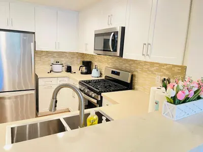 a kitchen with white cabinets and a stainless steel appliances at Luxury Irvine 2Bedrooms 2Bathrooms kitchen Pool apartment in Irvine
