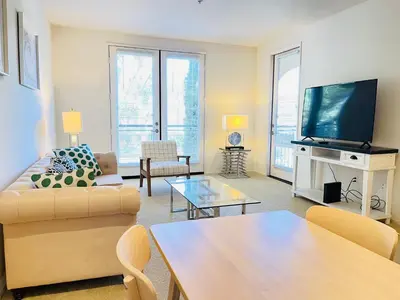 a living room with a couch and a flat screen tv at Luxury Irvine 2Bedrooms 2Bathrooms kitchen Pool apartment in Irvine