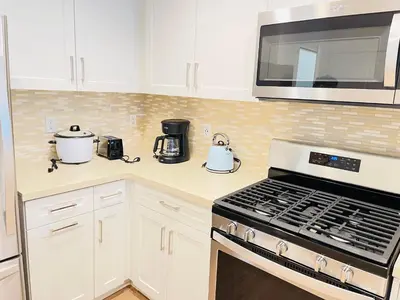 a kitchen with a stove and a microwave at Luxury Irvine 2Bedrooms 2Bathrooms kitchen Pool apartment in Irvine