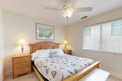 a bedroom with a bed and a ceiling fan at Cheery Retreat in Newport Beach