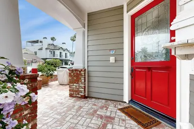 a red door on a house with a patio at Cheery Retreat in Newport Beach