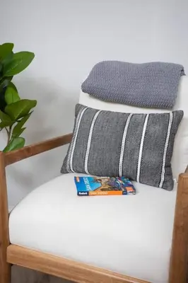 a stack of pillows sitting on a chair at Coastal, Elegant, Modern, King Bed in San Diego