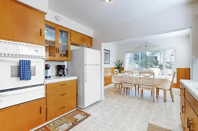 a kitchen with a table and a white refrigerator at Little Italy Charmer in San Diego