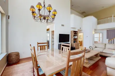 a dining room and living room with a table and chairs at Torrey Treats House in San Diego