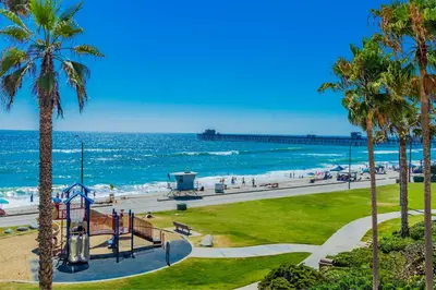 a view of a beach with palm trees and the ocean at Westwood House in Oceanside