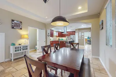 a dining room with a wooden table and chairs at Westwood House in Oceanside