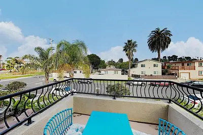 a balcony with chairs and a view of a street at Westwood House in Oceanside