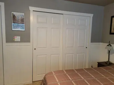 a bedroom with a white door and a bed at Casa de Taft in La Mesa
