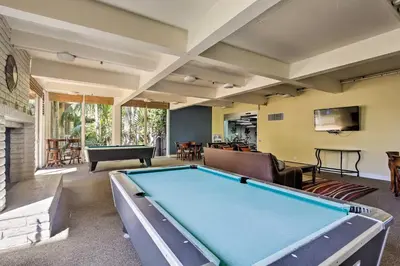 a large living room with a pool table at Stunning Oceanside Condo Walk to the Beach! in Oceanside