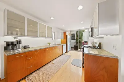 a kitchen with wooden cabinets and a counter top at New York Style Penthouse in the heart of the city in San Diego