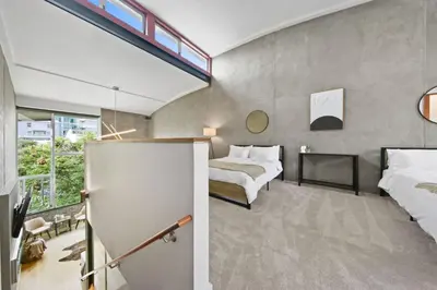 a bedroom with two beds and a large window at New York Style Penthouse in the heart of the city in San Diego