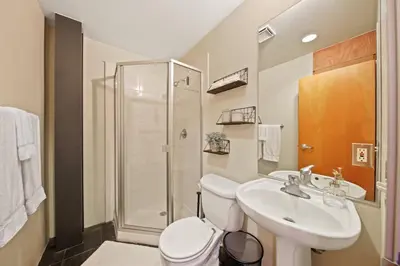 a bathroom with a toilet and a sink and a shower at New York Style Penthouse in the heart of the city in San Diego