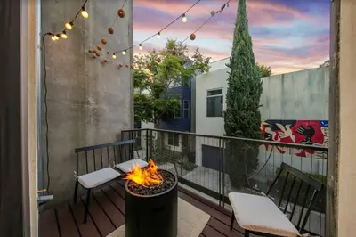 a patio with a fire pit on a balcony at New York Style Penthouse in the heart of the city in San Diego