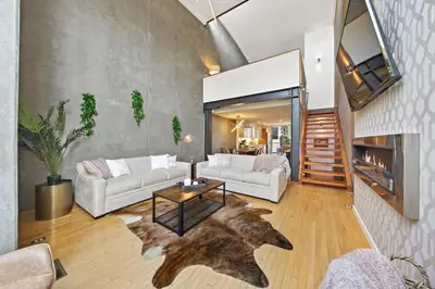 a living room with two white couches and a table at New York Style Penthouse in the heart of the city in San Diego