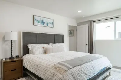 a white bedroom with a large bed and a window at The Rosemont III - La Jolla Luxury in San Diego