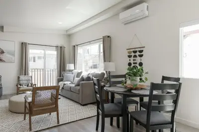 a living room with a table and a couch at The Rosemont IV - La Jolla Luxury in San Diego