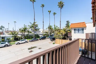 a balcony view of a parking lot with palm trees at The Rosemont IV - La Jolla Luxury in San Diego