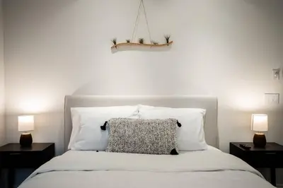 a bedroom with a white bed with two night stands at The San Diego Studio - Free Parking in San Diego