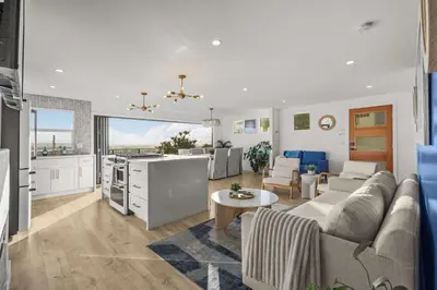 a living room and kitchen with a couch and a table at The California II - Mission Hills Hideaway in San Diego