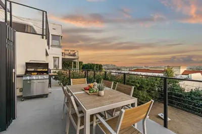 a patio with a table and chairs on a balcony at The California II - Mission Hills Hideaway in San Diego