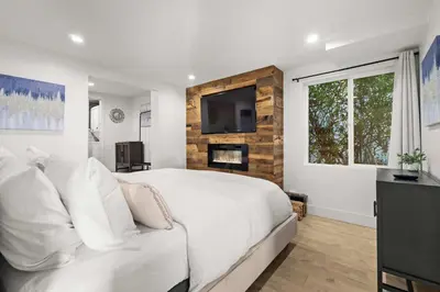 a bedroom with a white bed and a tv on a wall at The California II - Mission Hills Hideaway in San Diego