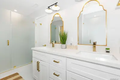a white bathroom with a sink and a mirror at The California II - Mission Hills Hideaway in San Diego