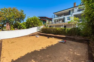a large yard with sand and a building at The California II - Mission Hills Hideaway in San Diego
