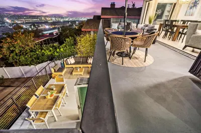 a balcony with a table and chairs on a building at The California III in San Diego