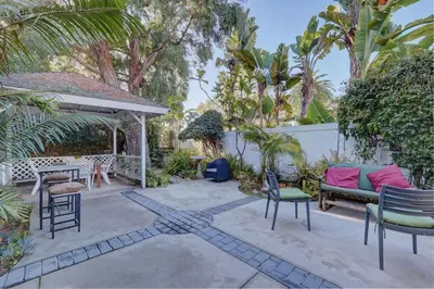 a patio with chairs and a table and a bench at Pelican Cove Inn in Carlsbad