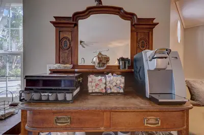 a dresser with a mirror and a printer on it at Pelican Cove Inn in Carlsbad