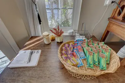 a table with a basket of candy on it at Pelican Cove Inn in Carlsbad