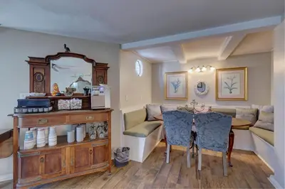 a dining room with a table and a mirror at Pelican Cove Inn in Carlsbad