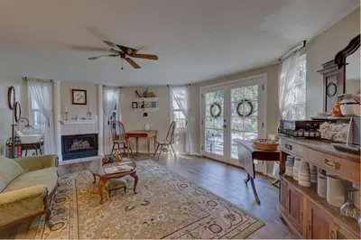 a living room with a ceiling fan and a living room at Pelican Cove Inn in Carlsbad