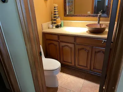 a bathroom with a sink and a toilet and a mirror at Rare Newport Coast Home for July & August this Summer in Newport Beach