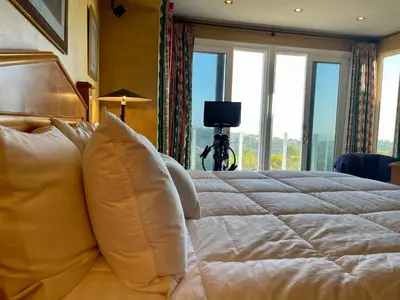 a bedroom with a large white bed with windows at Rare Newport Coast Home for July & August this Summer in Newport Beach