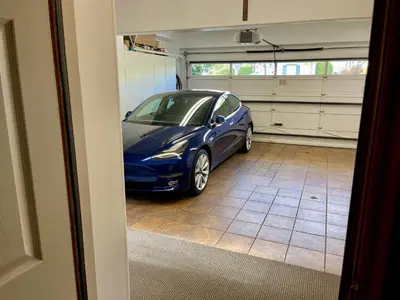 a blue car parked inside of a garage at Rare Newport Coast Home for July & August this Summer in Newport Beach