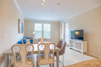 a dining room with a table and chairs and a tv at Luxury Irvine Spectrum 2 bedrooms 2 Bathrooms Kitchen pool Apartment in Irvine