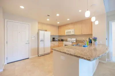 a kitchen with a counter top and a refrigerator at Luxury Irvine Spectrum 2 bedrooms 2 Bathrooms Kitchen pool Apartment in Irvine