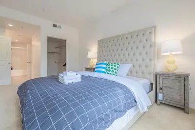 a bedroom with a blue and white bed with two lamps at Luxury Irvine Spectrum 2 bedrooms 2 Bathrooms Kitchen pool Apartment in Irvine